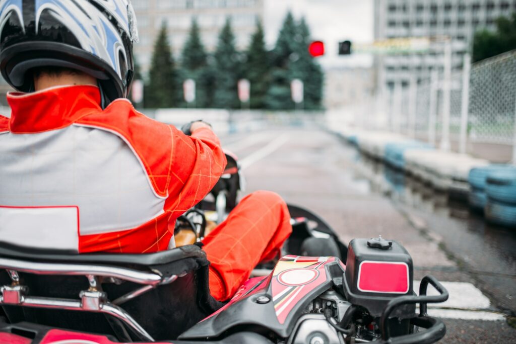 Karting racer, go kart driver in helmet, back view